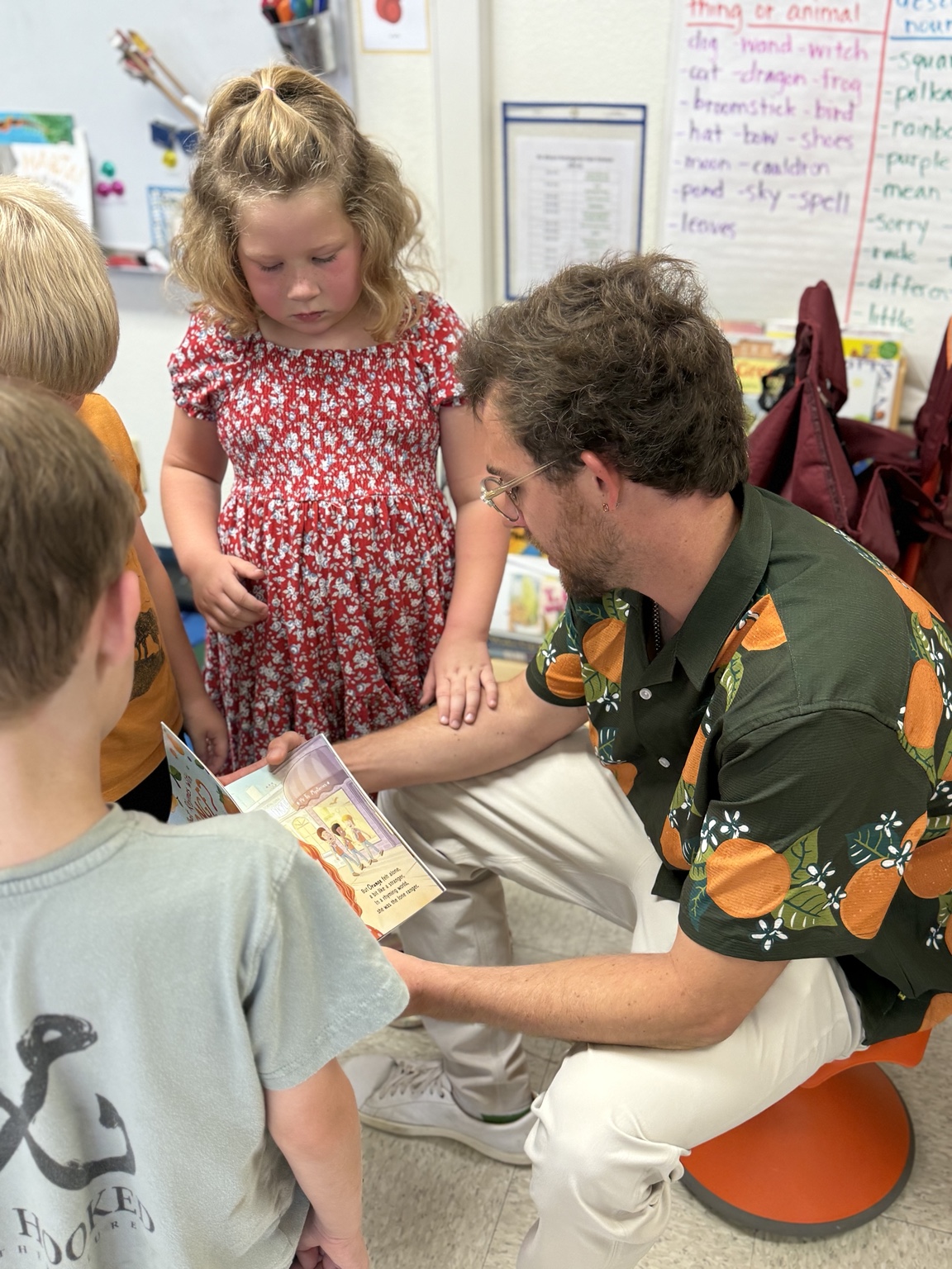 Mr B signing books for students after an Orange school visit