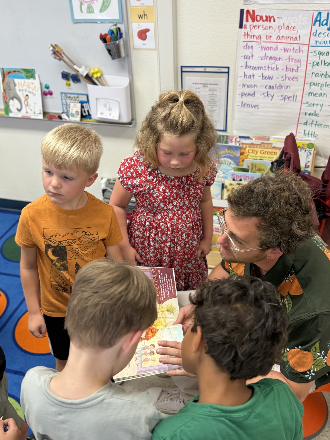 Students gathering around Mr B and the Orange book